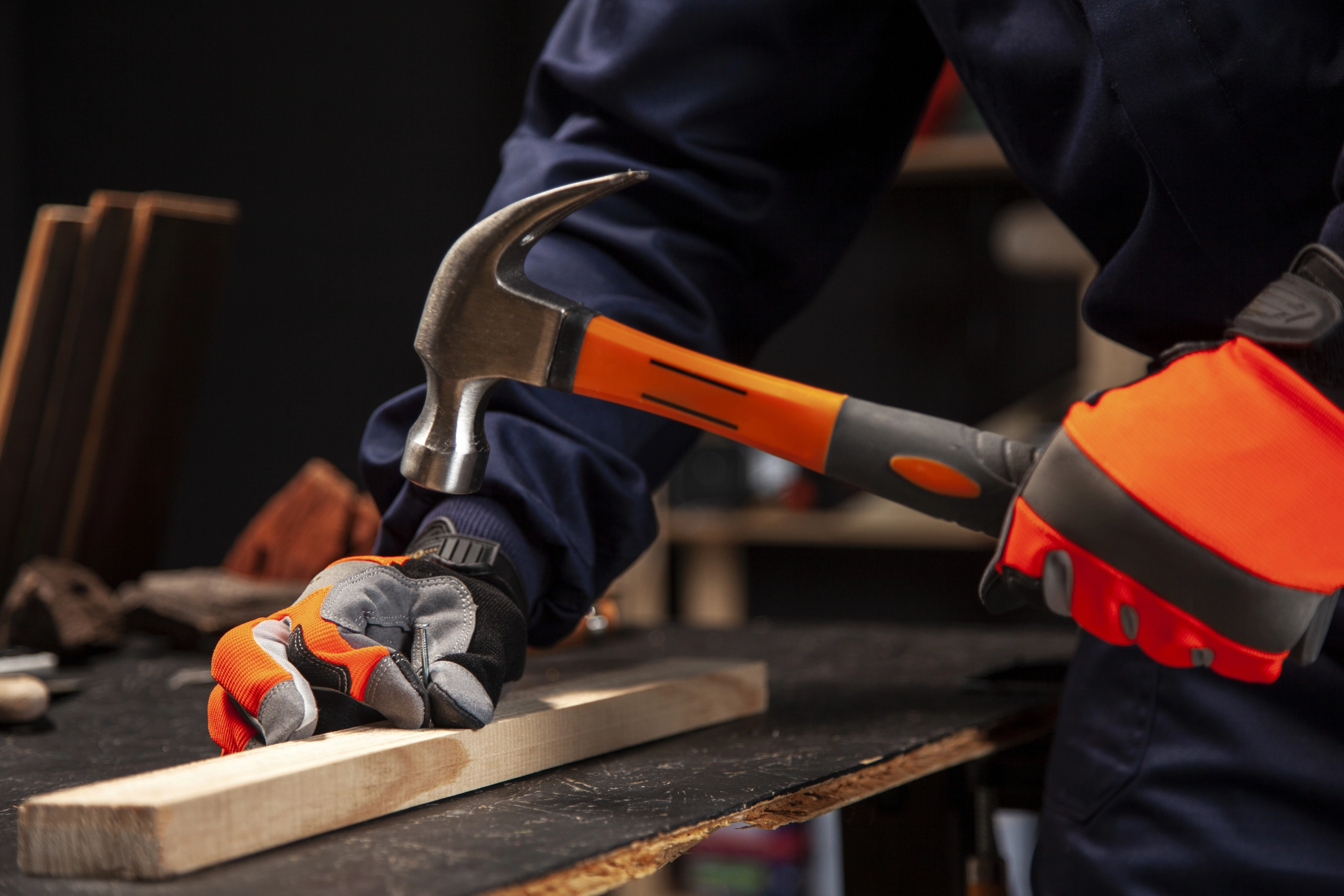 side-view-worker-using-hammer