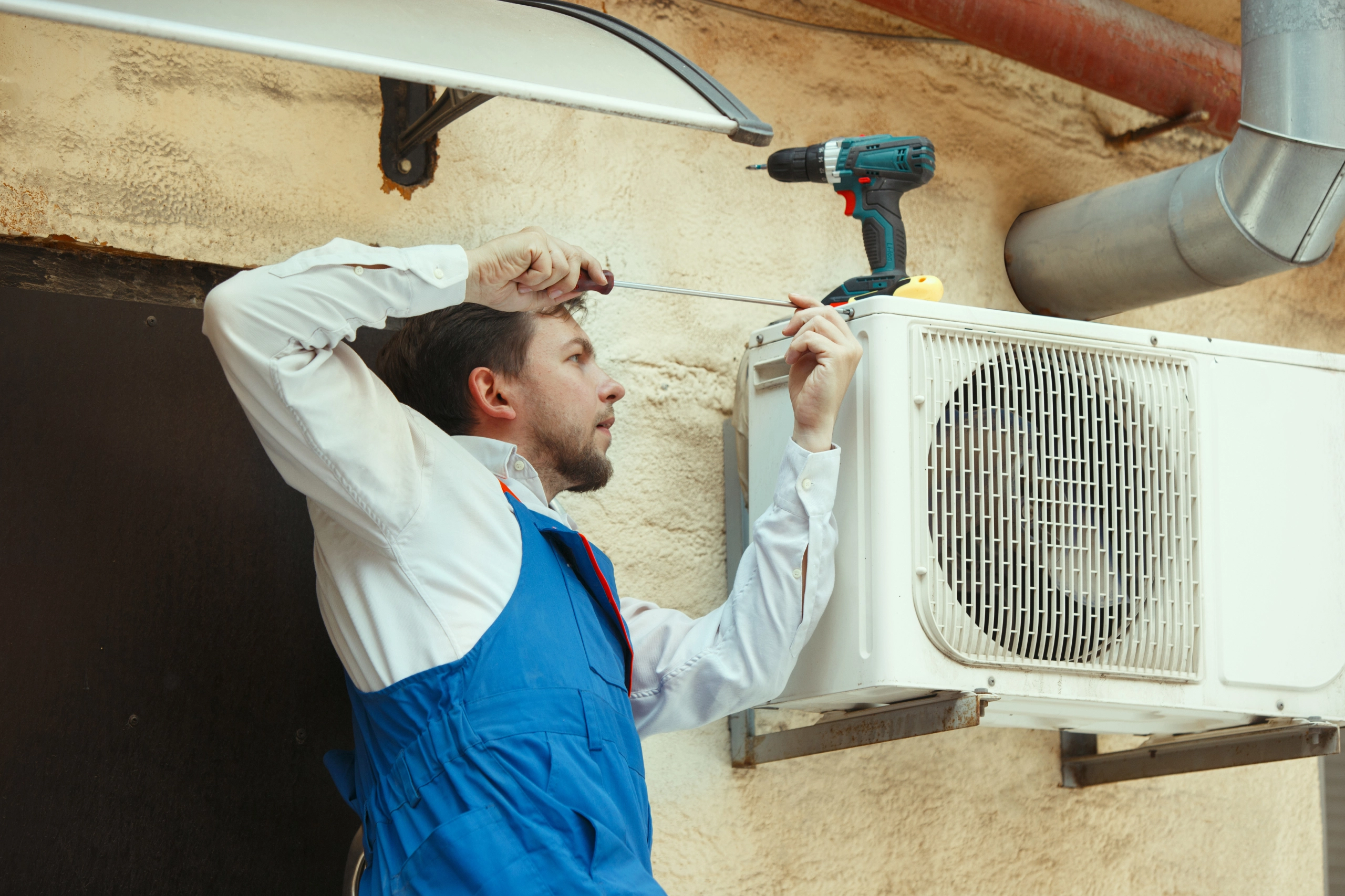 HVAC technician working on a capacitor part for condensing unit